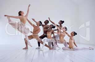 Creating beauty. Shot of a group of ballet dancers practicing a routine in a dance studio.