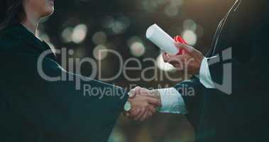 It took a lot of work and struggles to earn this diploma. Shot of a student receiving her diploma on graduation day.