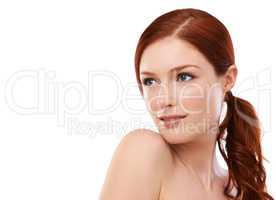 Theres a touch of elegance about her beauty. Studio shot of a redheaded woman isolated on white.