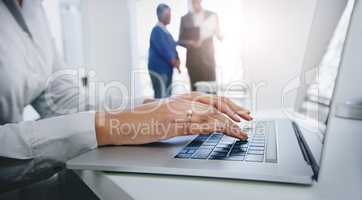 Technology gets the job done. Shot of a businesswoman using her laptop at the office.