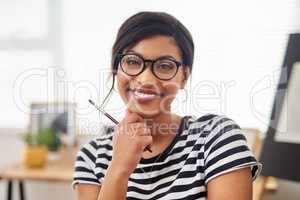 Creatives see life way more differently. Portrait of an attractive and artistic young woman holding a paintbrush while working in her studio at home.