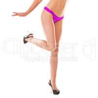 I have heels higher than your standards. Crop shot of a young woman wearing ping underwear against a white background.
