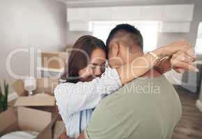 New home, new beginnings and new memories. Shot of a couple embracing each other while moving into their new home.