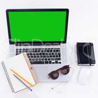 With the right tools, everyday can be a productive one. Shot of a laptop, glasses, mouse and notebook on a table.