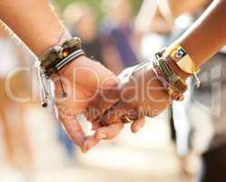 Cross-cultural friendship. Cropped closeup view of a multi-ethnic couple holding hands.