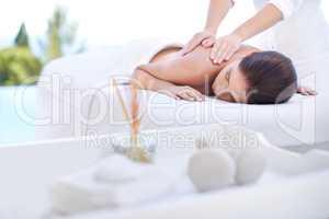 Being pampered. Cropped shot of an attractive young woman enjoying a relaxing massage.