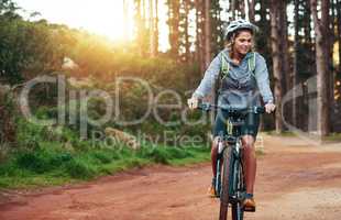 Shes an adventurous rider. Shot of a female mountain biker out for an early morning ride.