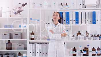 I hope my findings lead to something great. Shot of a young scientist looking at the notes written on a glass wall in a lab.