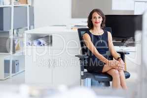 Ready to achieve even greater success. Portrait of a young designer sitting at her workstation in an office.