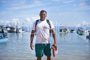 Fishing is my life. Portrait of a fisherman standing in shallow water in the harbor.