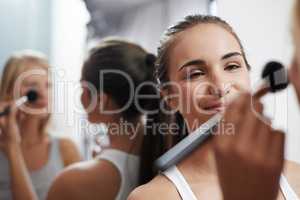 She knows how to apply makeup well. Two young women pampering themselves at a sleepover.