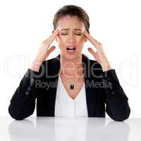 Headaches, what a pain. Studio shot of a young businesswoman experiencing a headache against a white background.