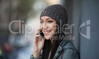 His call brought a smile to her face. Shot of an attractive young woman out in the town.