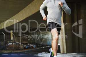 Beating barriers. Cropped image of a young man going for a run.