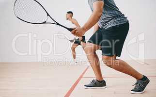 Gotta stay light on your feet. Shot of two young men playing a game of squash.