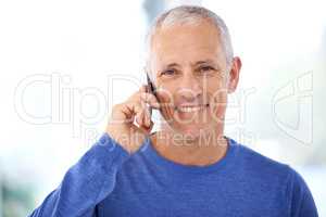 Keeping in touch with friends and family. A mature man having a pleasant phone conversation.