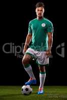 Ready for kick-off. Full length studio shot of a handsome young soccer player isolated on black.