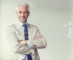 Experience and success build confidence. Portrait of a mature businessman standing in an office.