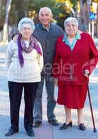 Getting older gracefully. Portrait of three elderly people standing outdoors.
