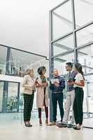 Business is built on a solid foundation of relationships. Shot of a group of colleagues having an informal meeting in an office.