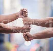 Working on success together. Cropped shot of two unrecognisable businessmen standing together with their fists stacked.