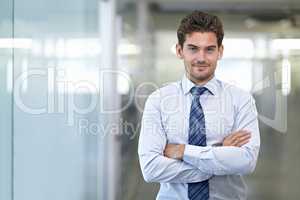 Hes a mover and shaker. Shot of a young businessman in a corporate office.