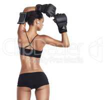 Shes in her prime. Rearview studio shot of a fit young woman wearing MMA gloves isolated on white.