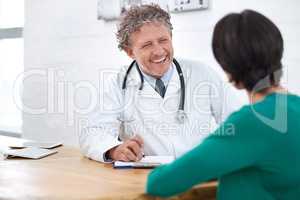 Hes got a wonderful bedside manner. Shot of a smiling mature doctor having a consultation with a patient.