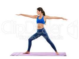 Perfect technique. Shot of a sporty young woman practicing yoga against a white background.