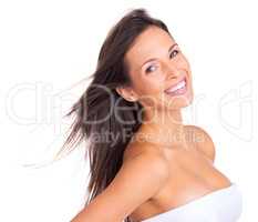 Radiant with happiness. Studio portrait of a beautiful young woman with silky brown hair looking happy.