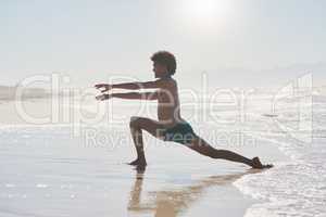 Dancing is just the movement of the soul. Full length shot of a handsome young man dancing shirtless on the beach during the day.