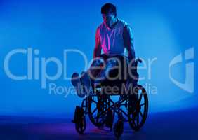 The only disability is a bad attitude. Blue filtered shot of a man exercising while sitting in his wheelchair.