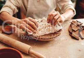 This design will sell like hotcakes. Cropped shot of an unrecognizable artisan working in a pottery workshop.