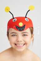 Precious little bug. Studio portrait of a cute little girl wearing a funny hat.