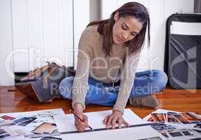 Working to develop her portfolio. A young woman working on her portfolio at home.