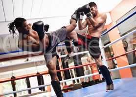 Training for the big day. Two kickboxers in training.
