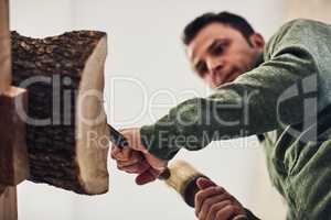 Theres something therapeutic about whittling. Cropped shot of an artist carving something out of wood.