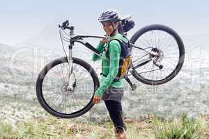 What an exhilarating hobby. A pretty young woman holding her mountain bike.