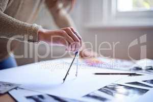Working hard on her creative vision. Cropped shot of a woman working on her portfolio.