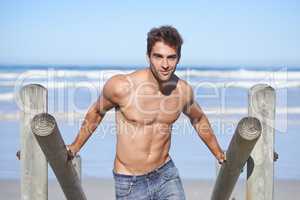 Feeling the summer vibes. A young man at the beach.