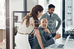 Any input. Cropped shot of three businesspeople working on a laptop in their office.