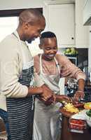 They love cooking together. Cropped shot of an affectionate young couple preparing dinner in their kitchen.