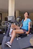 Working towards those calf muscles shes always dreamed of. Shot of a young ethnic woman working out in the gym on a stationary bike.