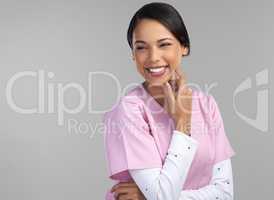 No other profession would make her this happy. Cropped shot of an attractive young female healthcare worker standing in studio against a grey background.