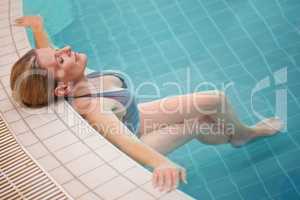 Feeling at one with the water. Cropped shot of a mature woman relaxing in an indoor swimming pool.