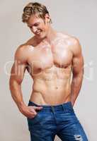 The beauty of the masculine form. Cropped shot of a muscular young man posing in studio.