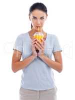 Healthy and delicious. Studio shot of a beautiful young woman enjoying a fruit smoothie.