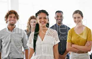 Theyre a dedicated team. Cropped portrait of a diverse group of young colleagues standing in a brightly lit office.