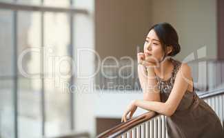 High society dreamer. Shot of an elegantly dressed young woman.