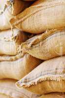 Valuable commodities.... Shot of burlap sacks filled with beans waiting for export.